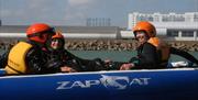People in a power boat on Hove Lagoon.