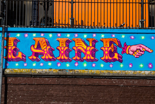 Photo of a street art sign directing people towards the North Laine area of Brighton