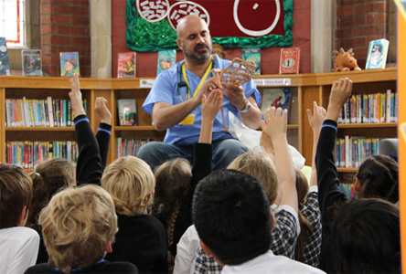 Marc Abraham talking to children at a school